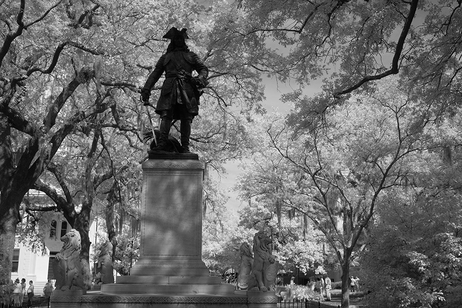 Infrared Photo of Square with Live Oaks, Spanish Moss and Statue in Deep Relief.